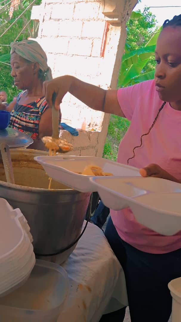 A volunteer serving meals during a community outreach activity
